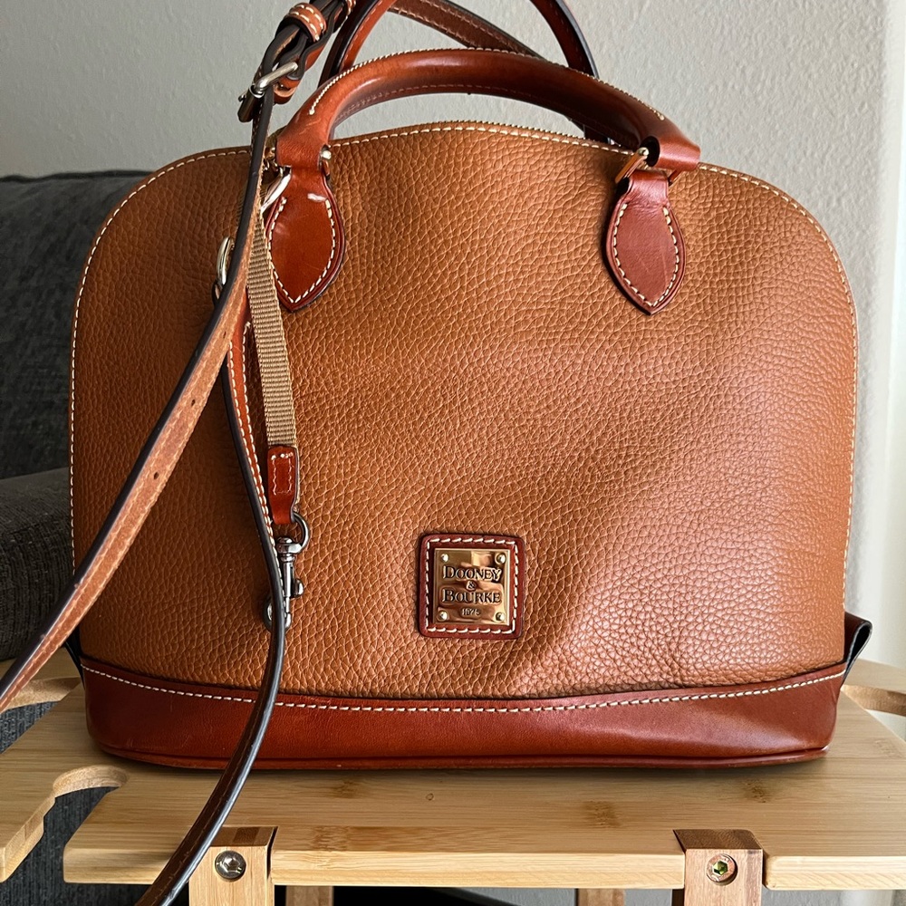 Hand Bag has 4 pockets inside one with zipper with cross body strap